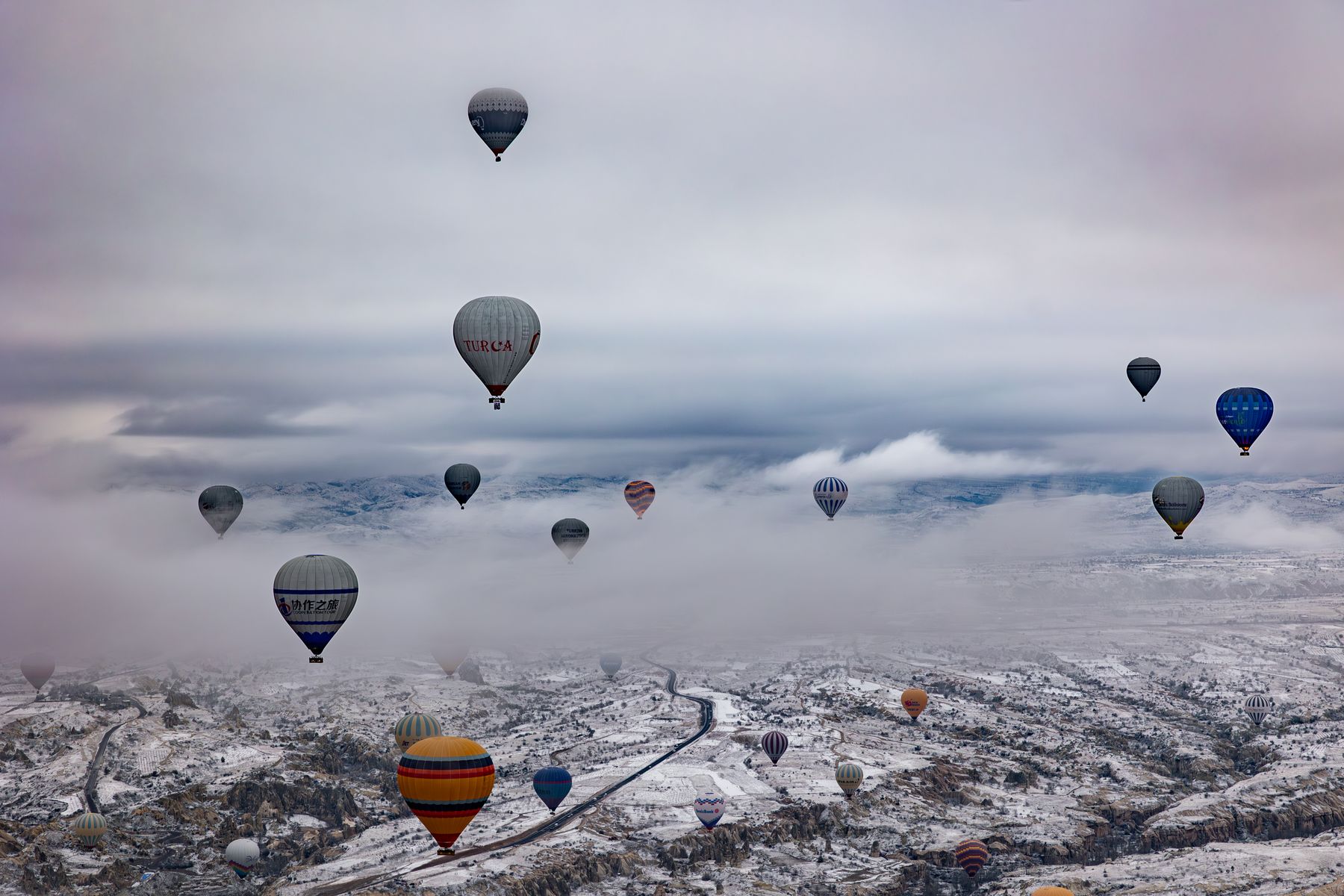Hot Air Balloons Over a Snow-Capped Cappadocia